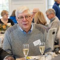 Event guests seated at table in conversation with each other